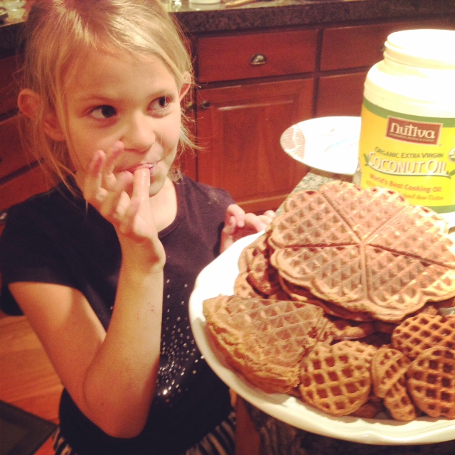 Young girl eating waffles